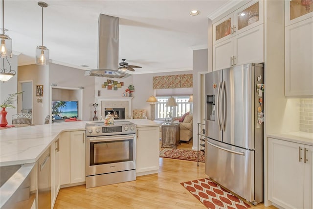 kitchen featuring exhaust hood, hanging light fixtures, stainless steel appliances, and light hardwood / wood-style floors