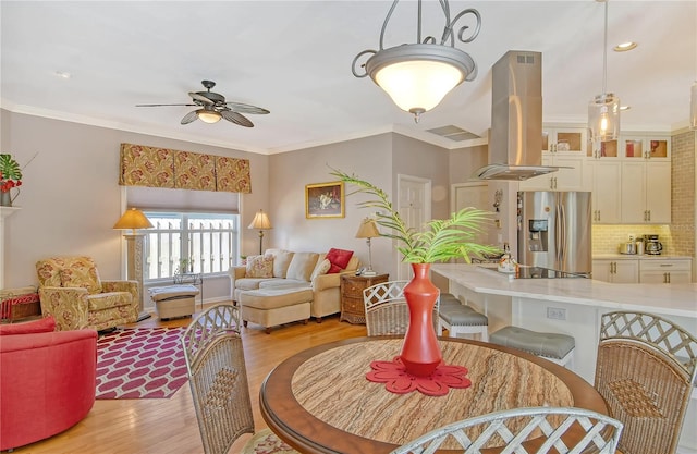 interior space featuring light hardwood / wood-style floors, crown molding, and ceiling fan