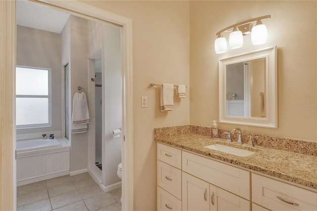 full bathroom featuring vanity, shower with separate bathtub, toilet, and tile patterned floors