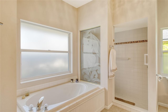 bathroom featuring tile patterned flooring and separate shower and tub