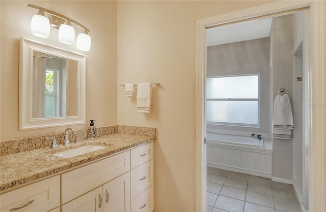 bathroom with vanity, a tub to relax in, and tile patterned floors