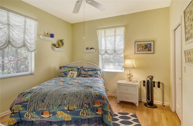 bedroom with light hardwood / wood-style floors and ceiling fan