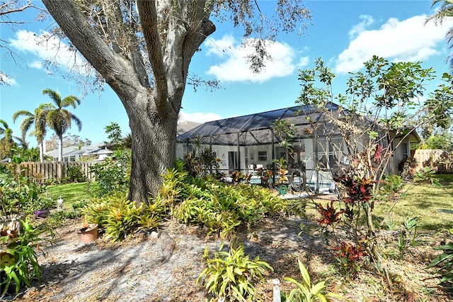 view of yard with a patio and glass enclosure