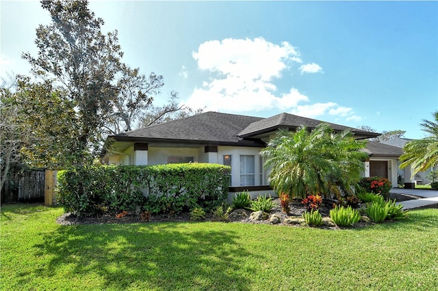 view of front of property with a garage and a front lawn