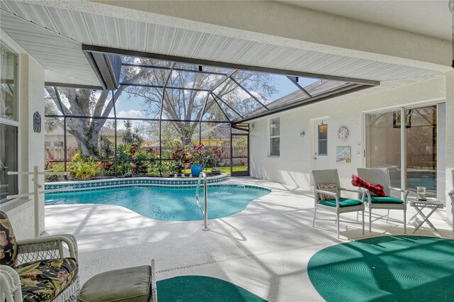 view of pool featuring a patio and glass enclosure