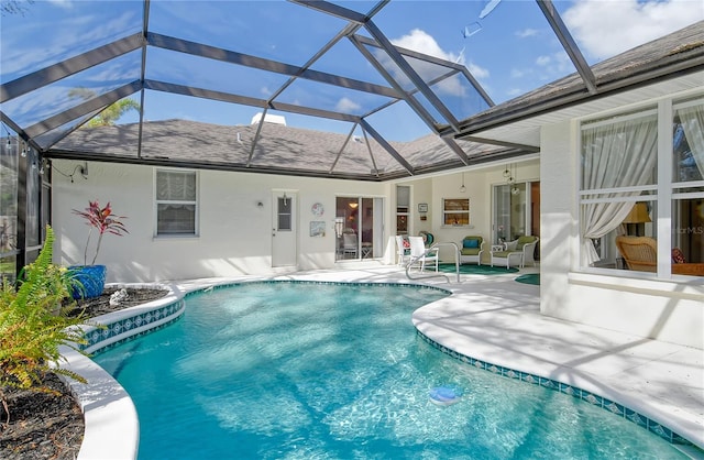 view of swimming pool featuring a patio area and a lanai