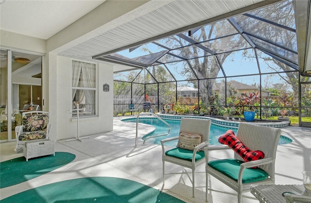 view of pool featuring a patio, ceiling fan, and glass enclosure