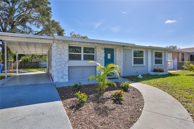 ranch-style house featuring a garage and a carport