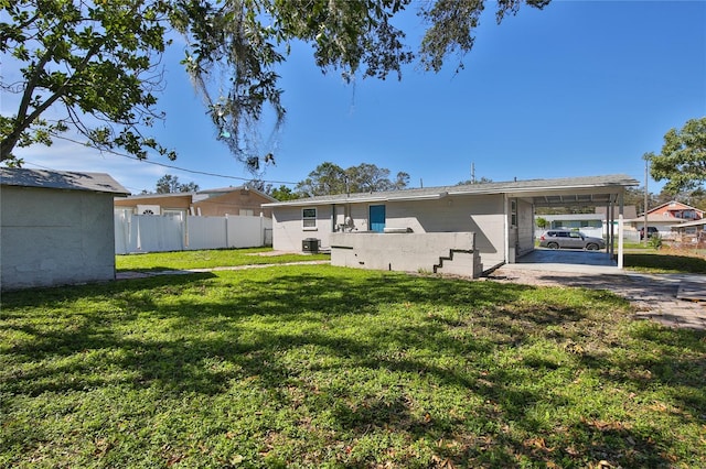 rear view of property with a yard