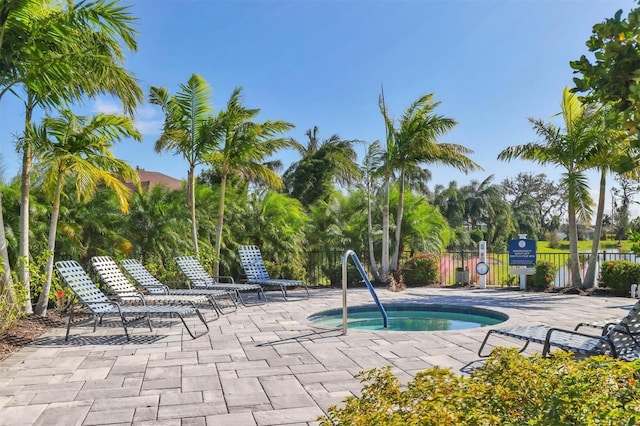 view of swimming pool with a community hot tub and a patio area