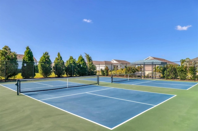 view of tennis court with basketball hoop