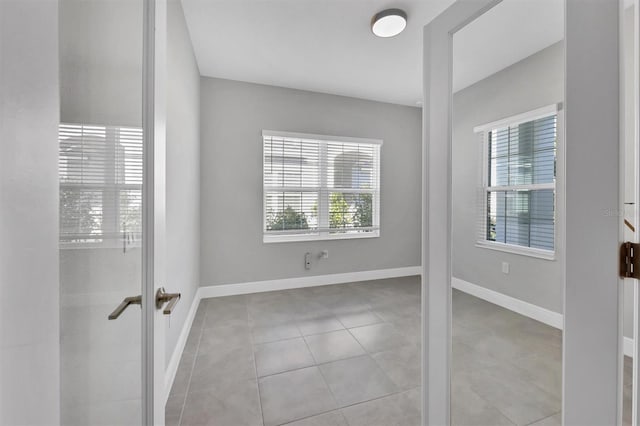 tiled empty room with french doors