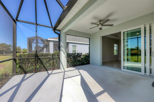 unfurnished sunroom with ceiling fan