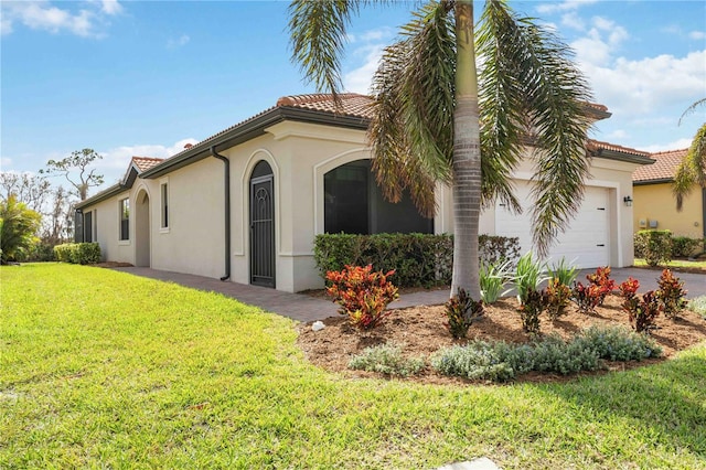 view of side of property with a garage and a yard