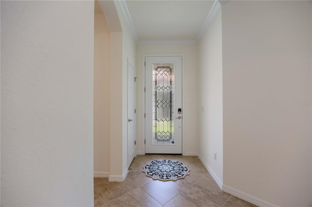 entryway with light tile patterned floors and ornamental molding