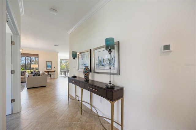 hallway featuring light tile patterned floors and crown molding