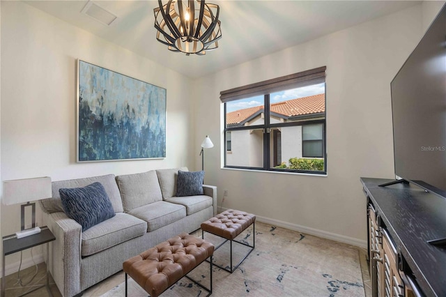 carpeted living room with an inviting chandelier