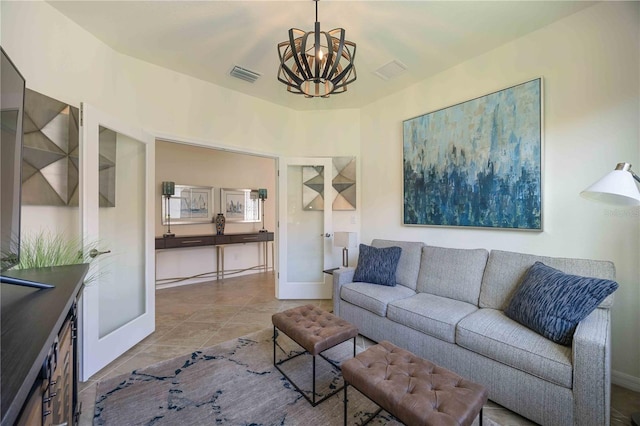 living room with light tile patterned floors and a notable chandelier