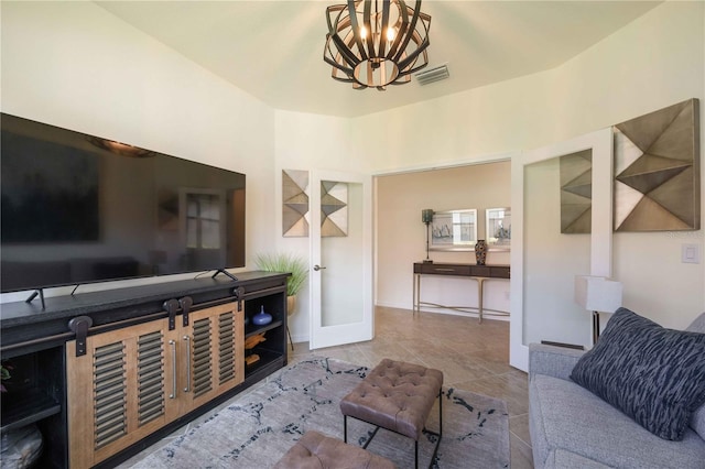 tiled living room featuring a notable chandelier