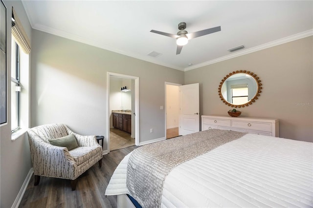 bedroom with dark wood-type flooring, crown molding, ceiling fan, and ensuite bath