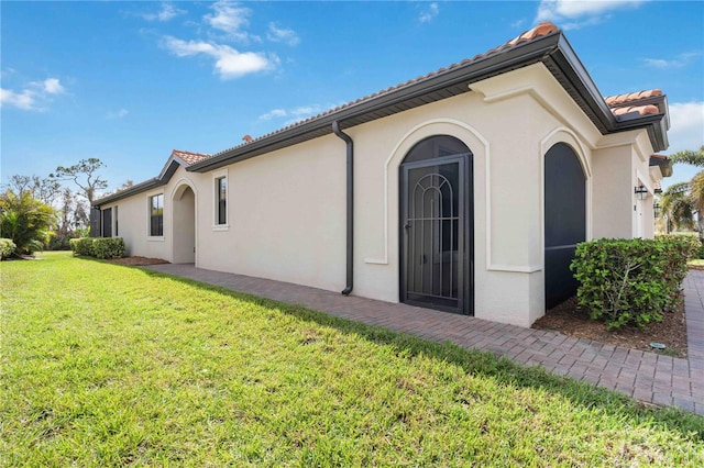 view of property exterior featuring a lawn