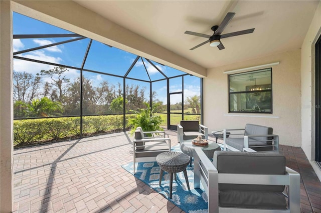 view of patio featuring glass enclosure, outdoor lounge area, and ceiling fan