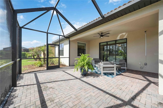 unfurnished sunroom featuring ceiling fan