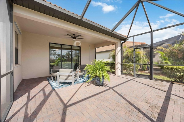 unfurnished sunroom with ceiling fan