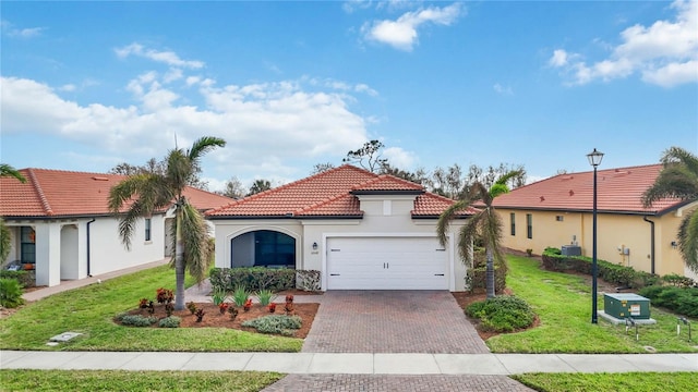 mediterranean / spanish-style home featuring a garage and a front yard