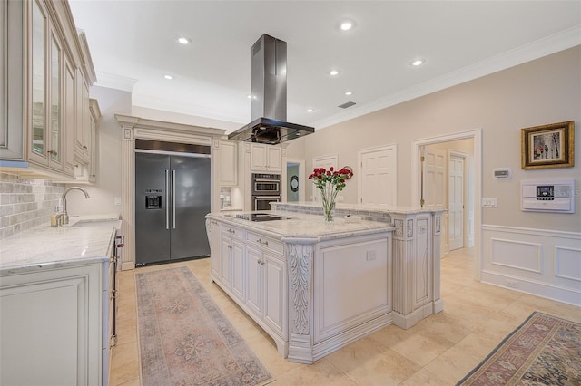 kitchen featuring backsplash, a large island with sink, island range hood, sink, and stainless steel appliances