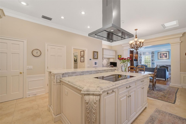 kitchen featuring ornamental molding, black electric stovetop, island exhaust hood, and a center island