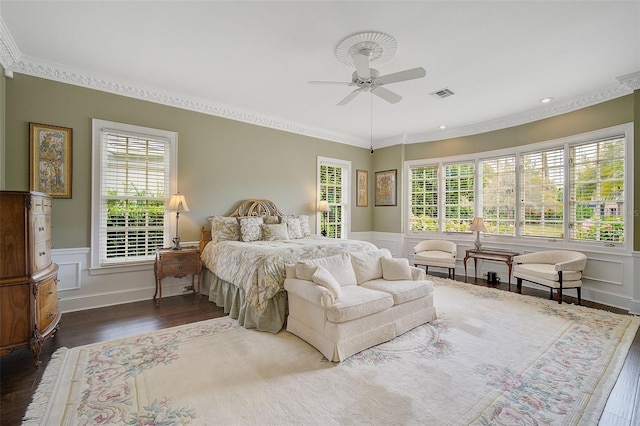 bedroom featuring ceiling fan, ornamental molding, and dark hardwood / wood-style floors