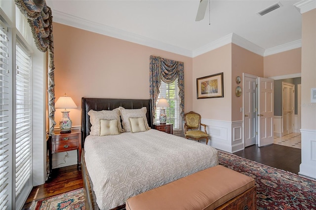 bedroom with ceiling fan, ornamental molding, and dark hardwood / wood-style floors