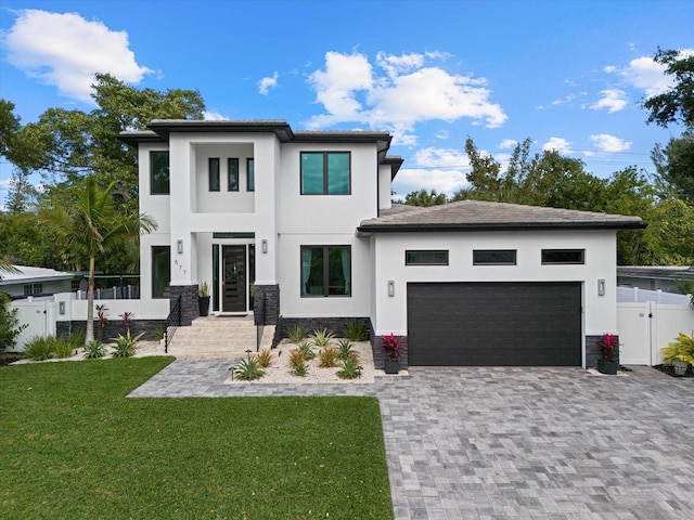 577 Venice Ln, Sarasota, FL 34242 - view of front facade featuring stucco siding, an attached garage, a gate, decorative driveway, and stone siding