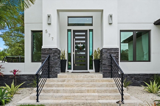 577 Venice Ln, Sarasota, FL 34242 - doorway to property with stone siding and stucco siding