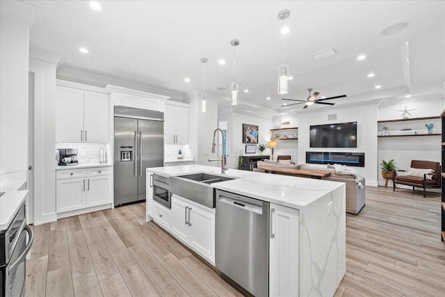 577 Venice Ln, Sarasota, FL 34242 - kitchen with appliances with stainless steel finishes, a sink, a ceiling fan, white cabinetry, and recessed lighting