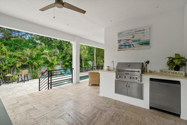 view of patio / terrace featuring exterior kitchen, grilling area, ceiling fan, and sink