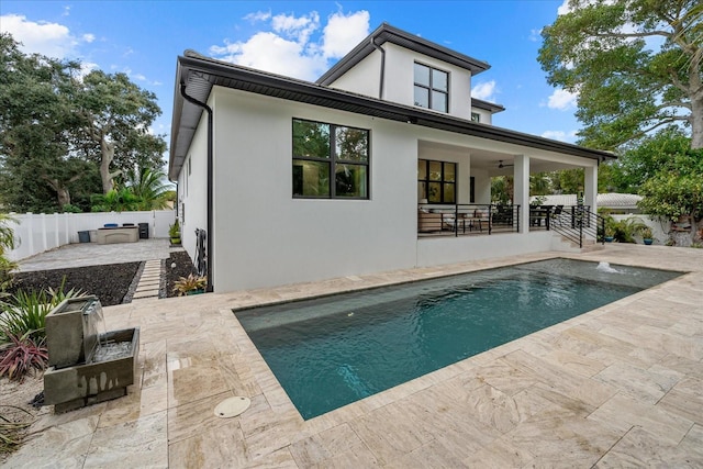 577 Venice Ln, Sarasota, FL 34242 - back of property with ceiling fan, a patio area, a fenced backyard, stucco siding, and area for grilling