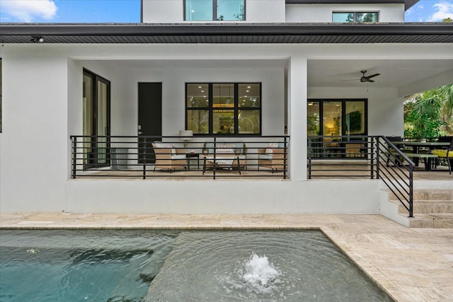 577 Venice Ln, Sarasota, FL 34242 - back of property featuring stucco siding, a ceiling fan, and covered porch