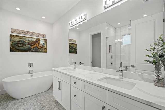 bathroom featuring tile patterned floors, vanity, and shower with separate bathtub