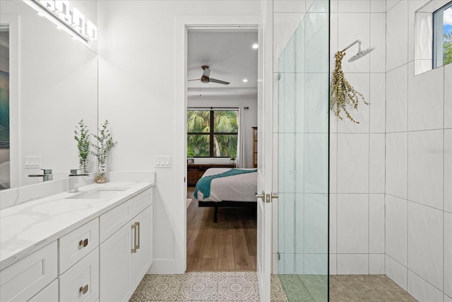 bathroom featuring ceiling fan, tiled shower, tile patterned floors, and vanity