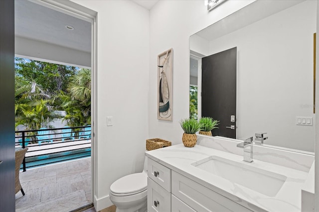 577 Venice Ln, Sarasota, FL 34242 - bathroom featuring vanity, toilet, and baseboards