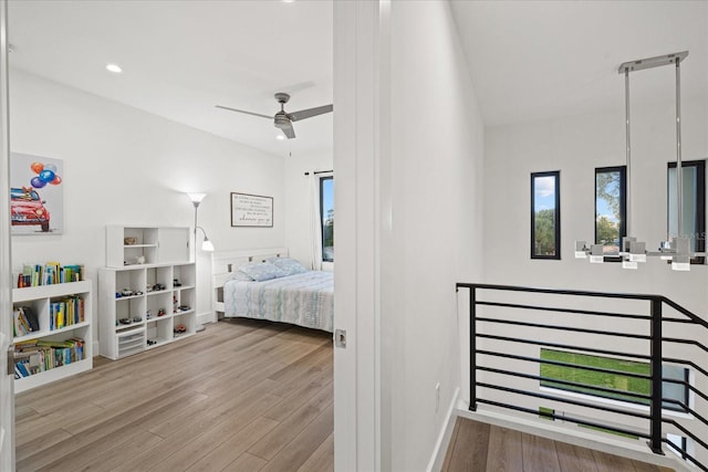 bedroom with ceiling fan and light hardwood / wood-style floors