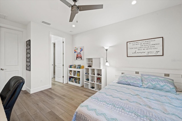 bedroom with ceiling fan and light hardwood / wood-style flooring