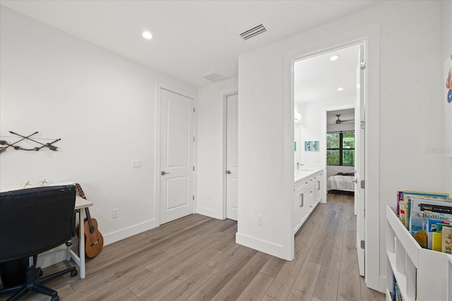 home office with ceiling fan and light hardwood / wood-style floors