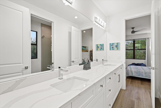 bathroom featuring ceiling fan, vanity, and wood-type flooring