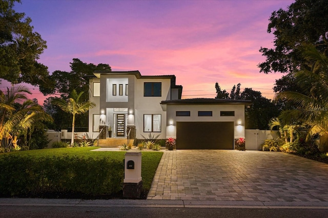 view of front facade with a lawn and a garage