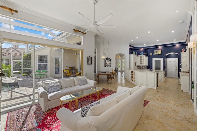 living room with ornamental molding and ceiling fan