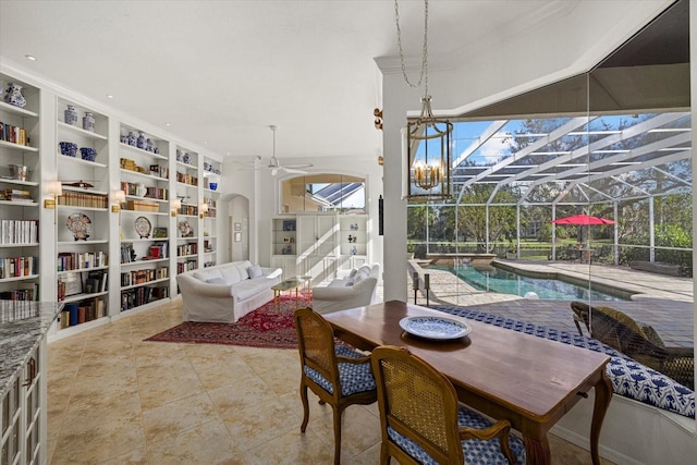 dining area featuring built in shelves, ornamental molding, and ceiling fan