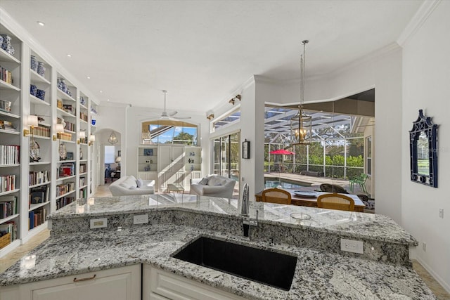 kitchen with white cabinets, plenty of natural light, and sink